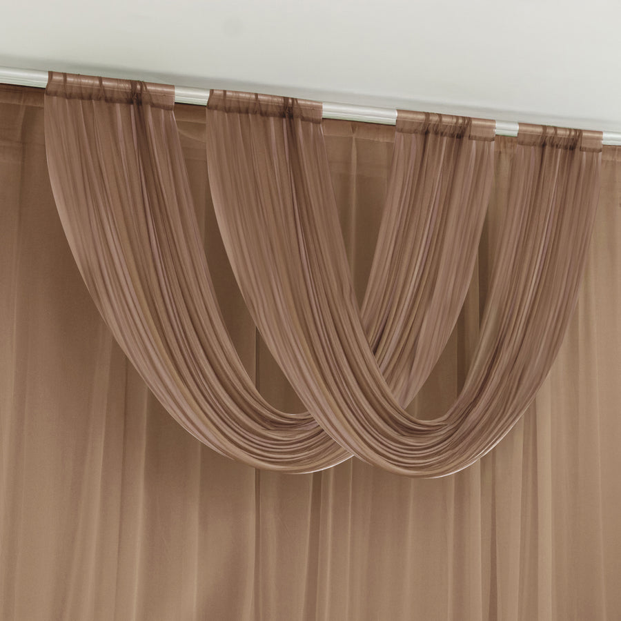 Brown sheer curtains draped over a rod against a white ceiling