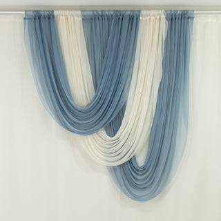 Blue and ivory layered sheer curtains hanging in a room