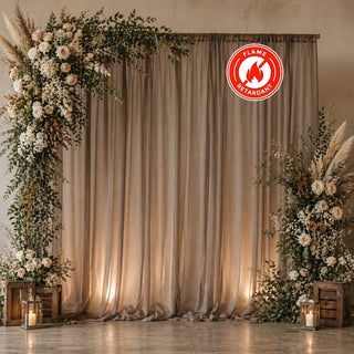 Elegant floral wedding backdrop with draped curtains and lanterns