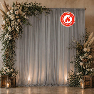 Elegant floral wedding backdrop with gray drapes and lantern candles
