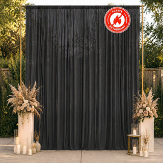 Black flame-retardant curtain backdrop with elegant floral wedding decor outdoors
