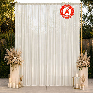 Elegant ivory wedding backdrop with floral arrangements and flame-retardant curtain