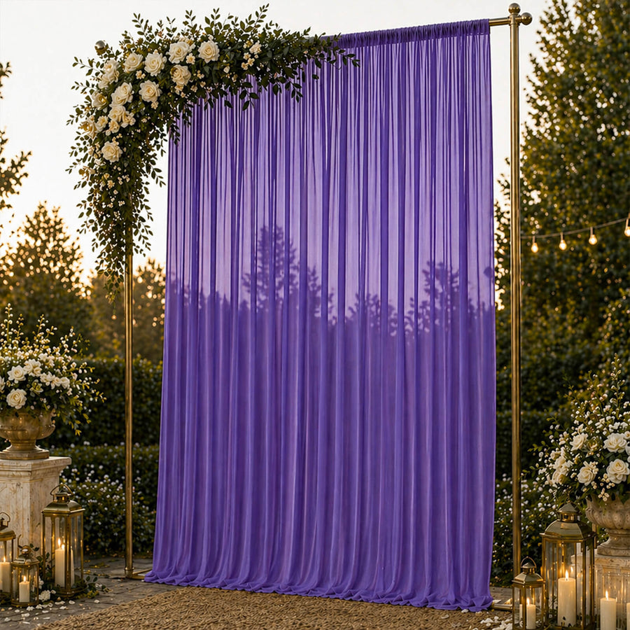 Purple wedding backdrop with floral arch, lanterns, and romantic outdoor decor