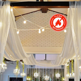 Flame retardant drapery with decorative lighting in an elegant indoor setting.