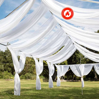Outdoor white drapery canopy setup for events in a garden setting.