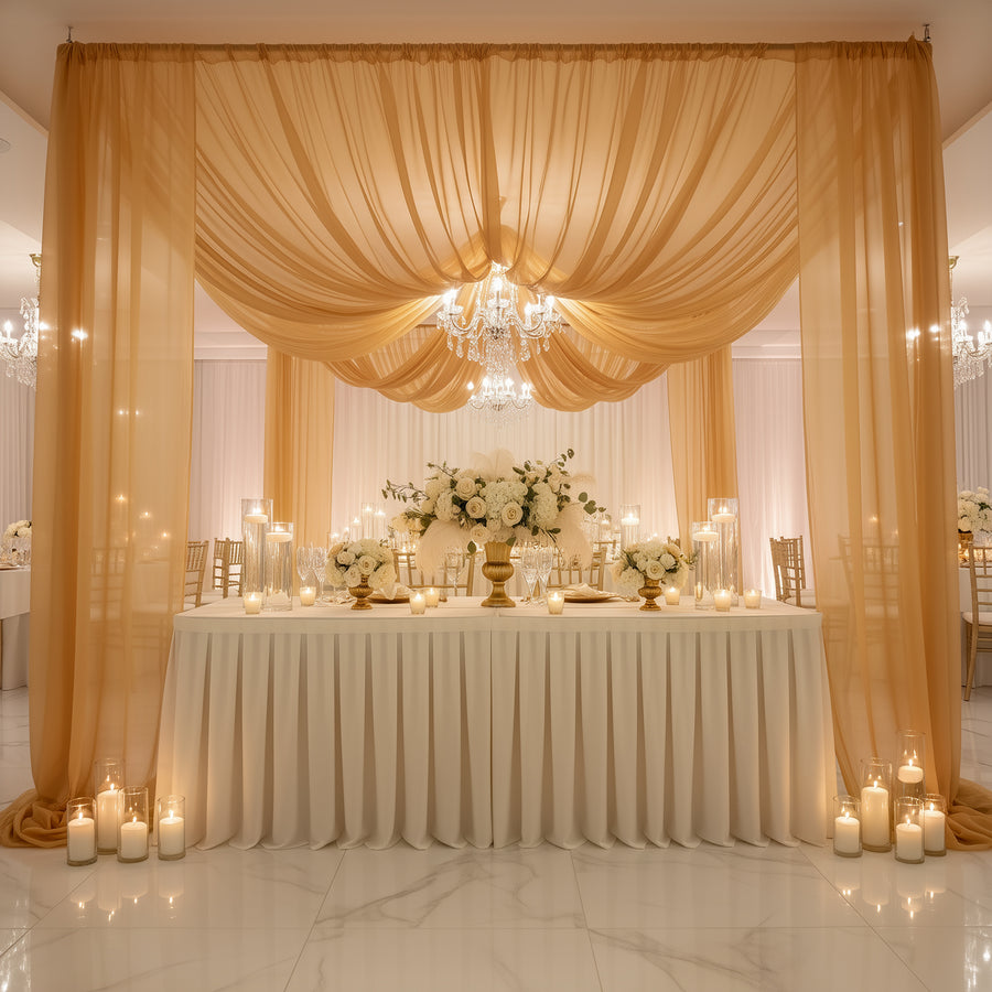 Elegant wedding reception setup with draped fabric, floral centerpieces, and soft lighting.