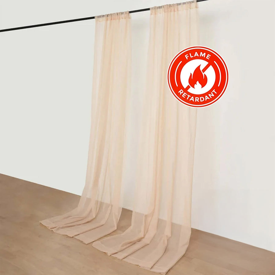 Flame-retardant sheer curtains in soft beige color, hanging on a rod.