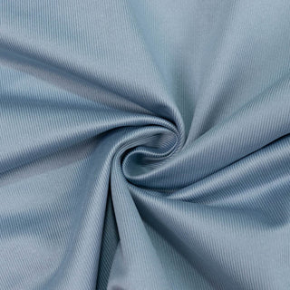 Light blue ribbed fabric with a twisted spiral fold close-up#whtbkgd