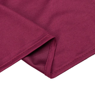 Maroon ribbed fabric close-up with folded hem detail