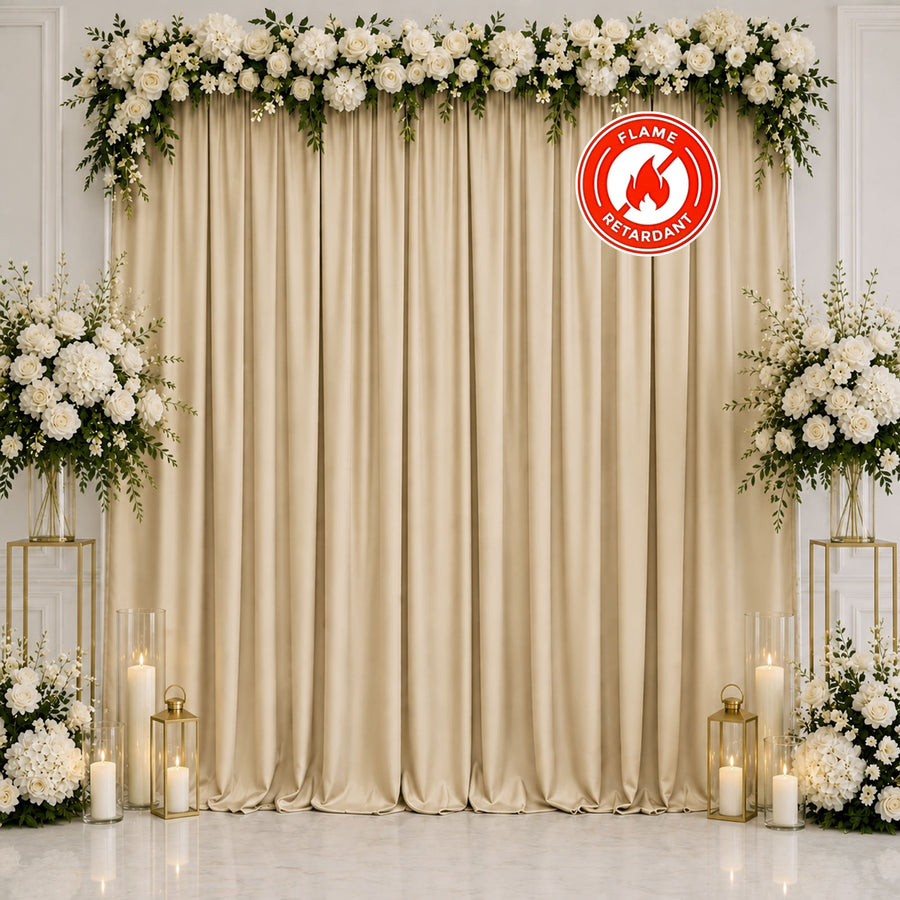 Elegant white floral wedding backdrop with gold curtains and candles