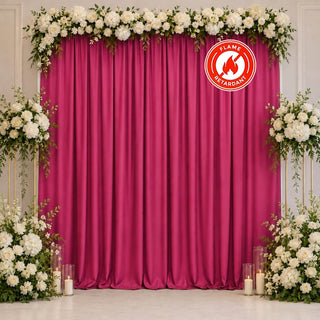 Floral magenta wedding backdrop with white roses and fire-retardant curtain