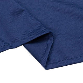 Blue ribbed knit fabric close-up with folded hem and seam detail