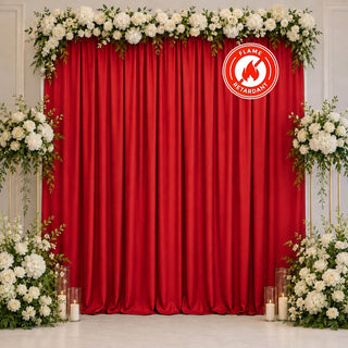 Red curtain floral wedding backdrop with white roses and candles