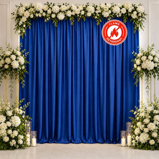 Royal blue wedding backdrop with white floral arch and candles