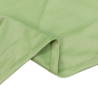 Light green ribbed knit fabric close-up with folded edge
