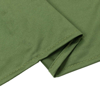 Olive green ribbed knit fabric close-up with stitched hem fold
