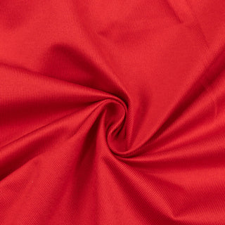 Red ribbed fabric texture with swirl fold pattern