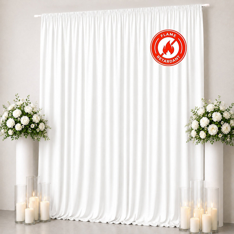 White flame retardant curtain backdrop with floral arrangements and candles