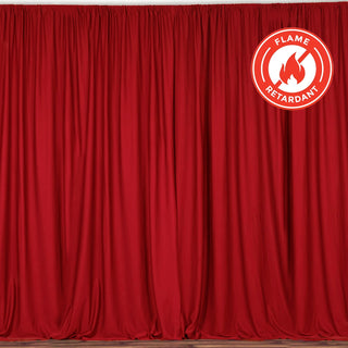 Red flame-retardant curtain draped elegantly, ideal for stage and event use. #whtbkgd