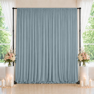 Elegant blue wedding backdrop with floral arrangements and candles by windows