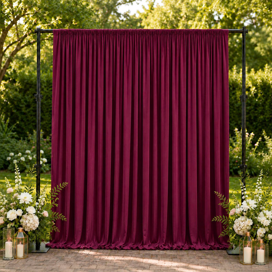 Burgundy velvet backdrop curtain with floral wedding decor outdoors