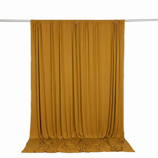 Mustard yellow draped curtain on hanging rod, studio backdrop