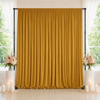 Gold wedding backdrop curtain with floral arrangements and candles