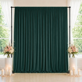 Elegant dark green wedding backdrop with floral arrangements and candles