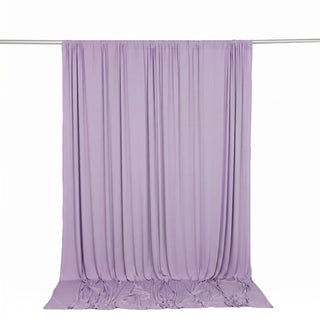 Light lavender sheer curtain draped on a rod with floor pooling fabric
