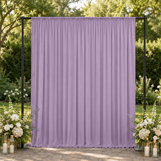 Lavender wedding backdrop with floral arrangements in an outdoor garden setting