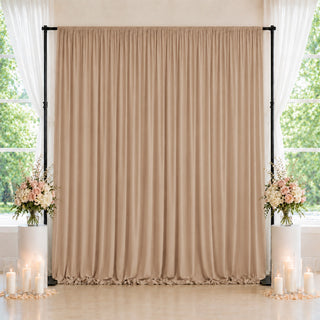 Elegant beige wedding backdrop with flowers and candles by bright windows