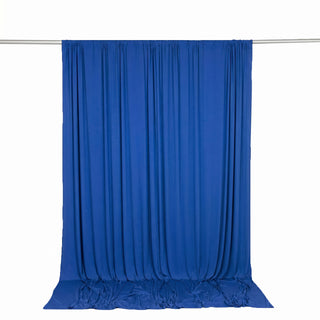 Blue fabric curtain backdrop on a rod with draped floor-length panels