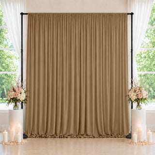 Elegant taupe wedding backdrop with floral arrangements and candle décor