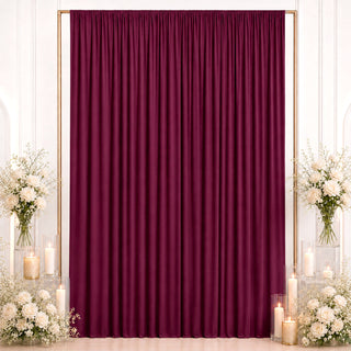 Elegant burgundy curtain backdrop with white roses and candles for events