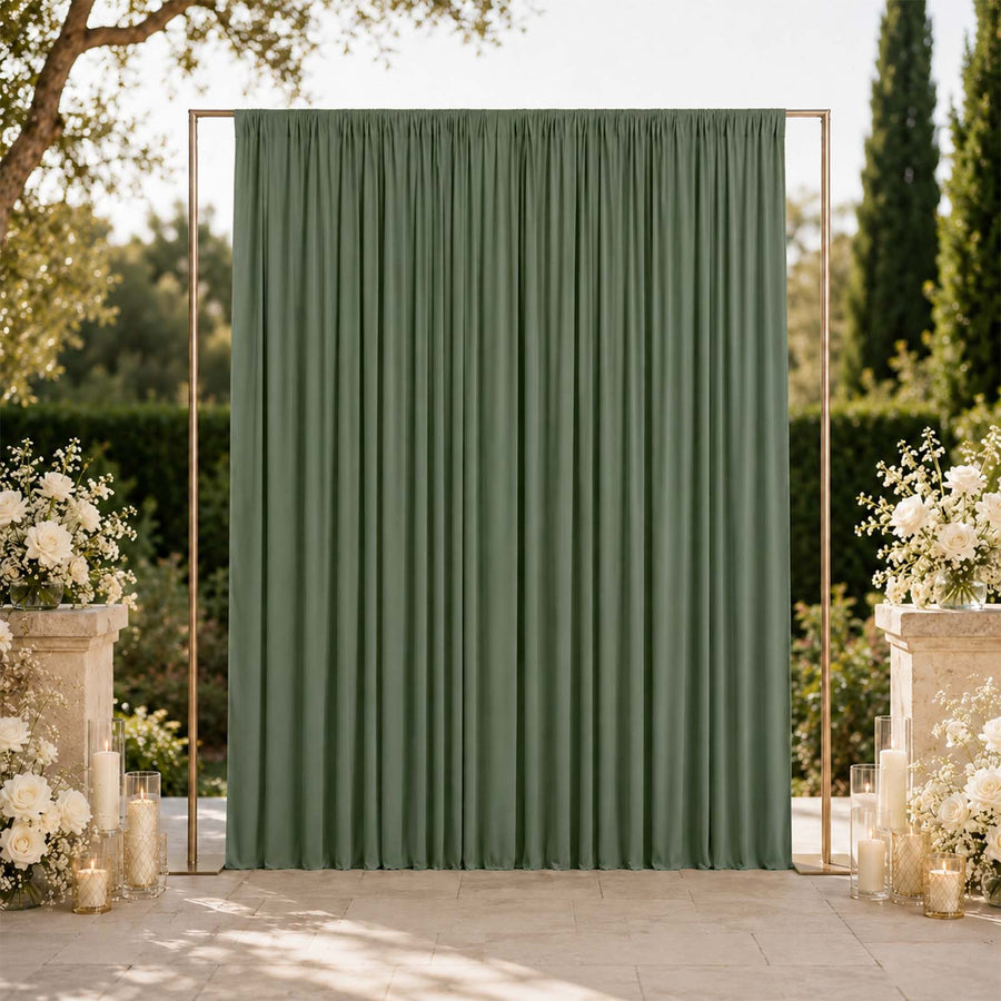 Green wedding backdrop curtain with gold frame and floral arrangements outdoors
