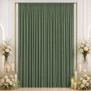 Elegant sage green curtain backdrop with white floral arrangements and candles