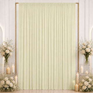 Elegant cream wedding backdrop with floral arrangements and candle decor