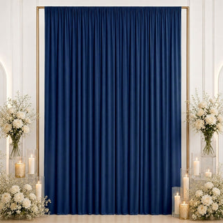 Elegant navy blue curtain backdrop with white roses, candles, and gold frame