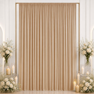 Elegant champagne draped curtain backdrop with white floral candle decor