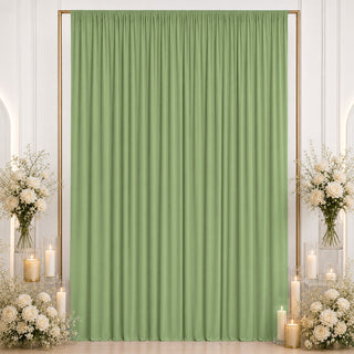 Elegant sage green curtain backdrop with white floral arrangements and candles