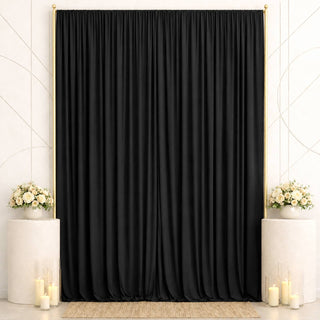 Elegant black wedding backdrop with gold frame, white flowers, and candles