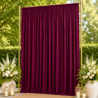 Burgundy velvet backdrop with gold frame, floral arrangements and lanterns