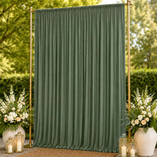 Green wedding backdrop curtain with gold frame and floral arrangements outdoors