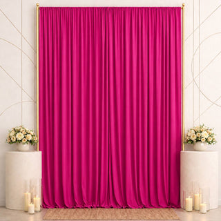 Pink satin backdrop with floral pedestals and candles for elegant event decor