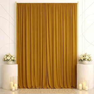 Elegant gold curtain backdrop with white floral arrangements and candles