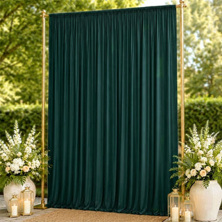 Elegant dark green wedding backdrop with gold frame and floral arrangements