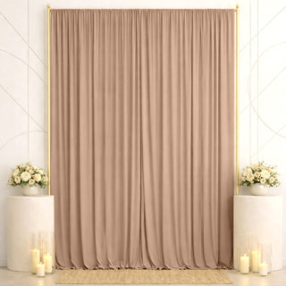 Elegant beige curtain backdrop with floral arrangements and candles