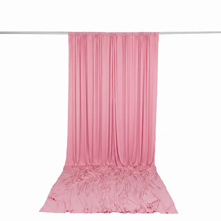 Pink draped fabric curtain backdrop on hanging rod with pooled floor fabric