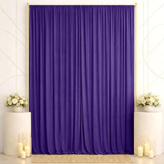 Elegant purple draped backdrop with floral accents and candles for events
