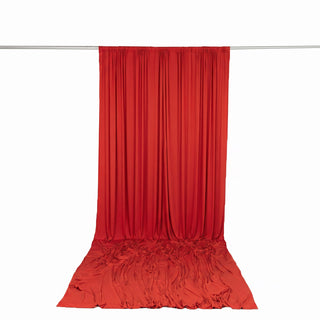 Red draped fabric backdrop on curtain rod, studio photography backdrop